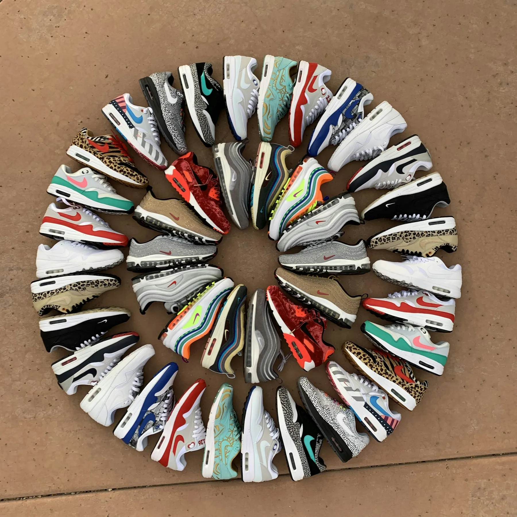 Circle of Nike Air Max sneakers laid out on the floor